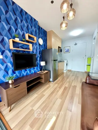 Modern living room with stylish decor, wooden flooring, and open kitchen layout in a contemporary apartment.