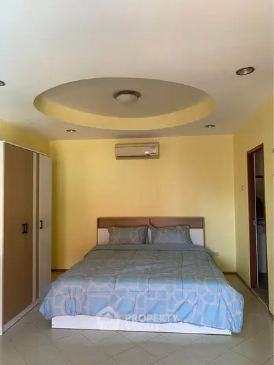 Spacious bedroom with modern design and air conditioning unit