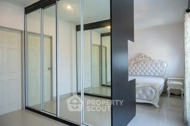 Elegant bedroom with mirrored wardrobe and luxurious bed frame