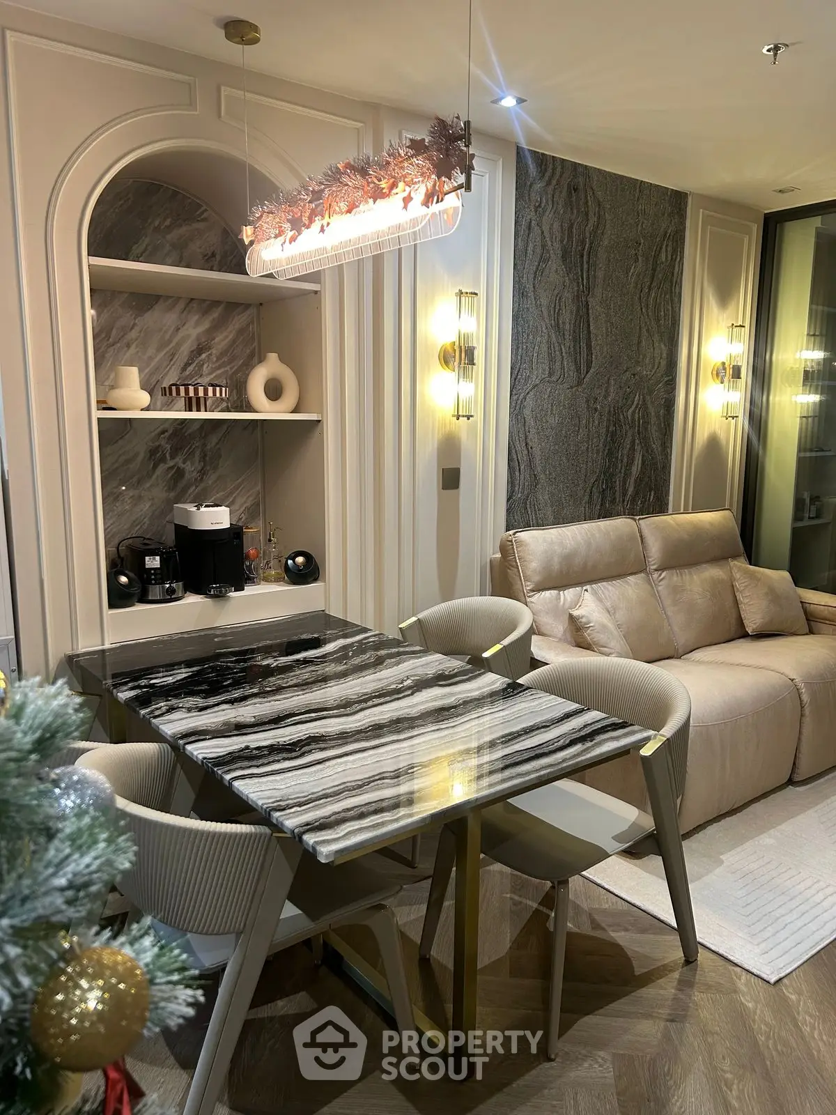 Luxurious modern living room with elegant marble dining table and cozy seating area.
