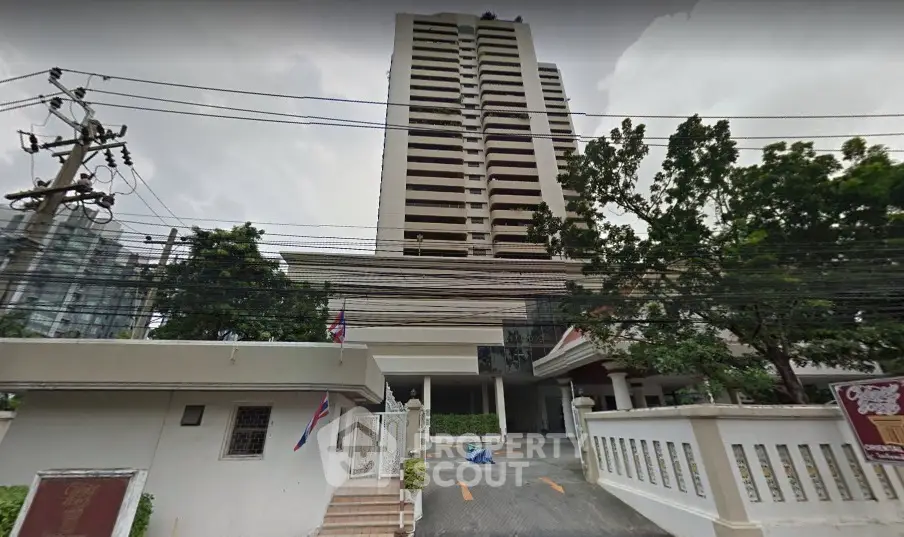 Stunning high-rise building with lush greenery and secure entrance in prime location.