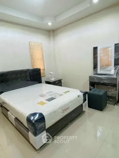 Modern bedroom with sleek furniture and stylish decor, perfect for a cozy living experience.