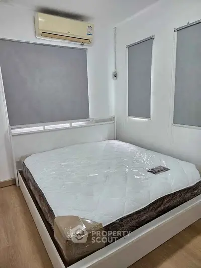 Cozy bedroom with air conditioning and modern blinds, perfect for restful nights.