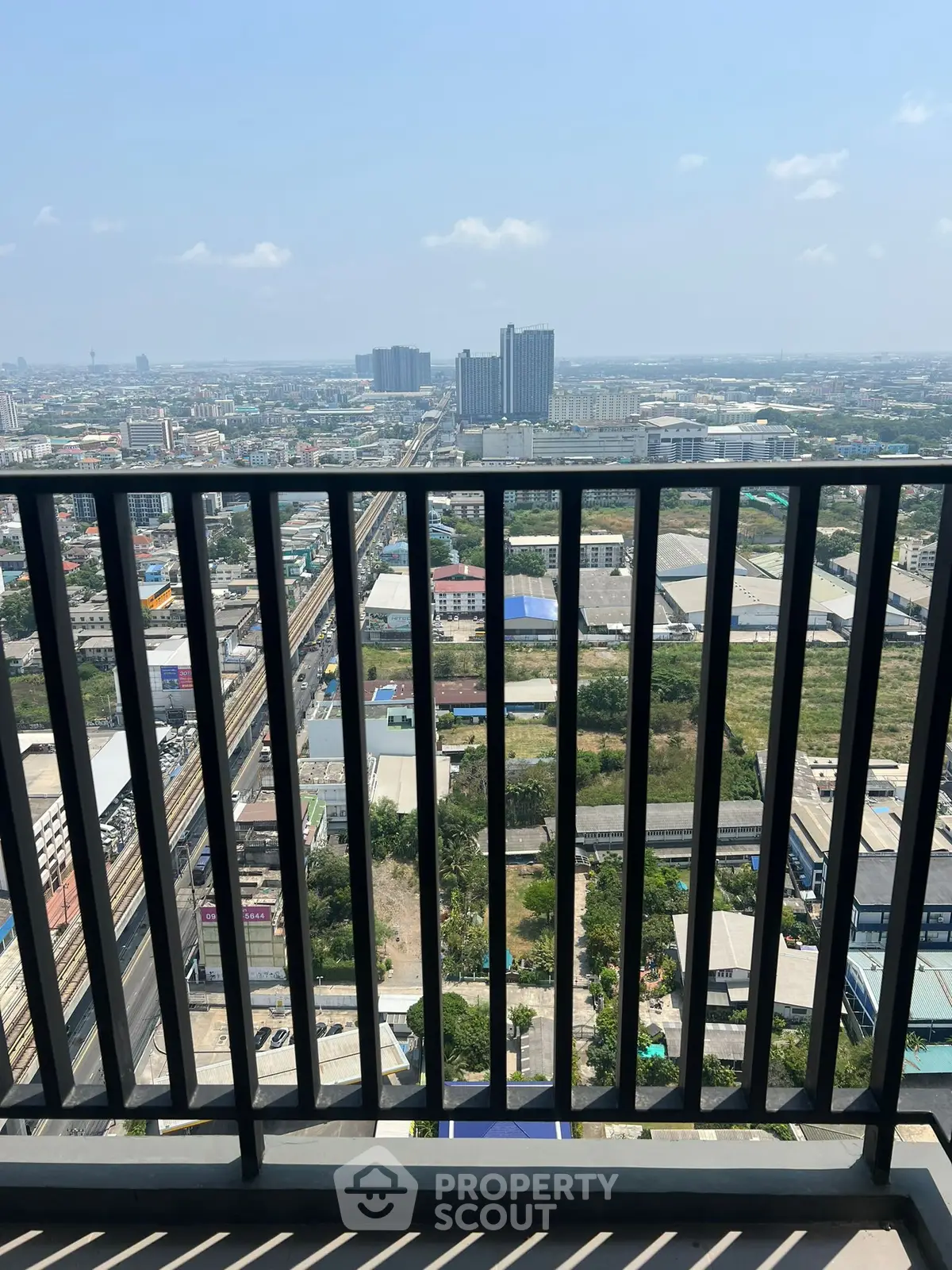 Stunning cityscape view from a high-rise balcony with expansive urban skyline.