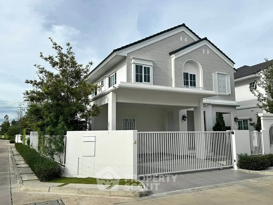 Charming two-story house with modern design and spacious driveway in a serene neighborhood.