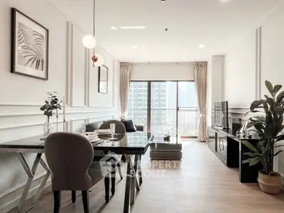 Stylish modern living room with dining area and city view balcony, perfect for urban living.