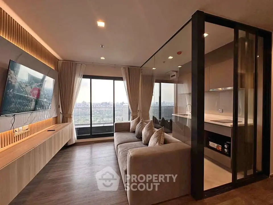 Modern living room with open kitchen and city view balcony in luxury apartment.