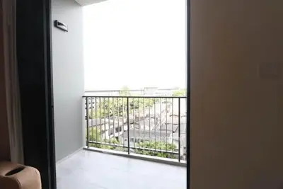 Modern apartment balcony with city view and sleek railing design.