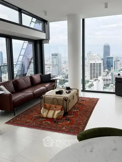 Luxurious living room with panoramic city views, elegant leather sofa, and stylish decor in a high-rise apartment.