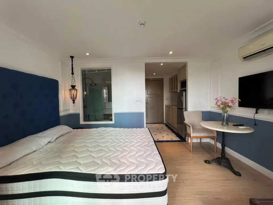 Charming bedroom with elegant decor and cozy ambiance, featuring a comfortable bed and stylish furnishings.