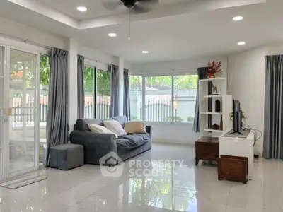 Spacious living room with modern decor and large windows offering natural light.
