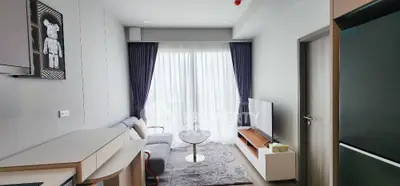 Modern living room with sleek furniture and large window for natural light.