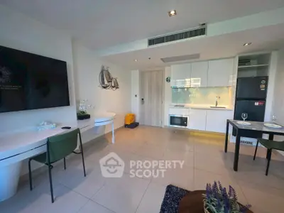 Modern open-plan living room with sleek kitchen and stylish decor