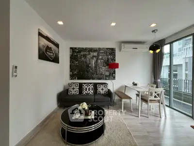 Modern living room with stylish decor and balcony view in a contemporary apartment.