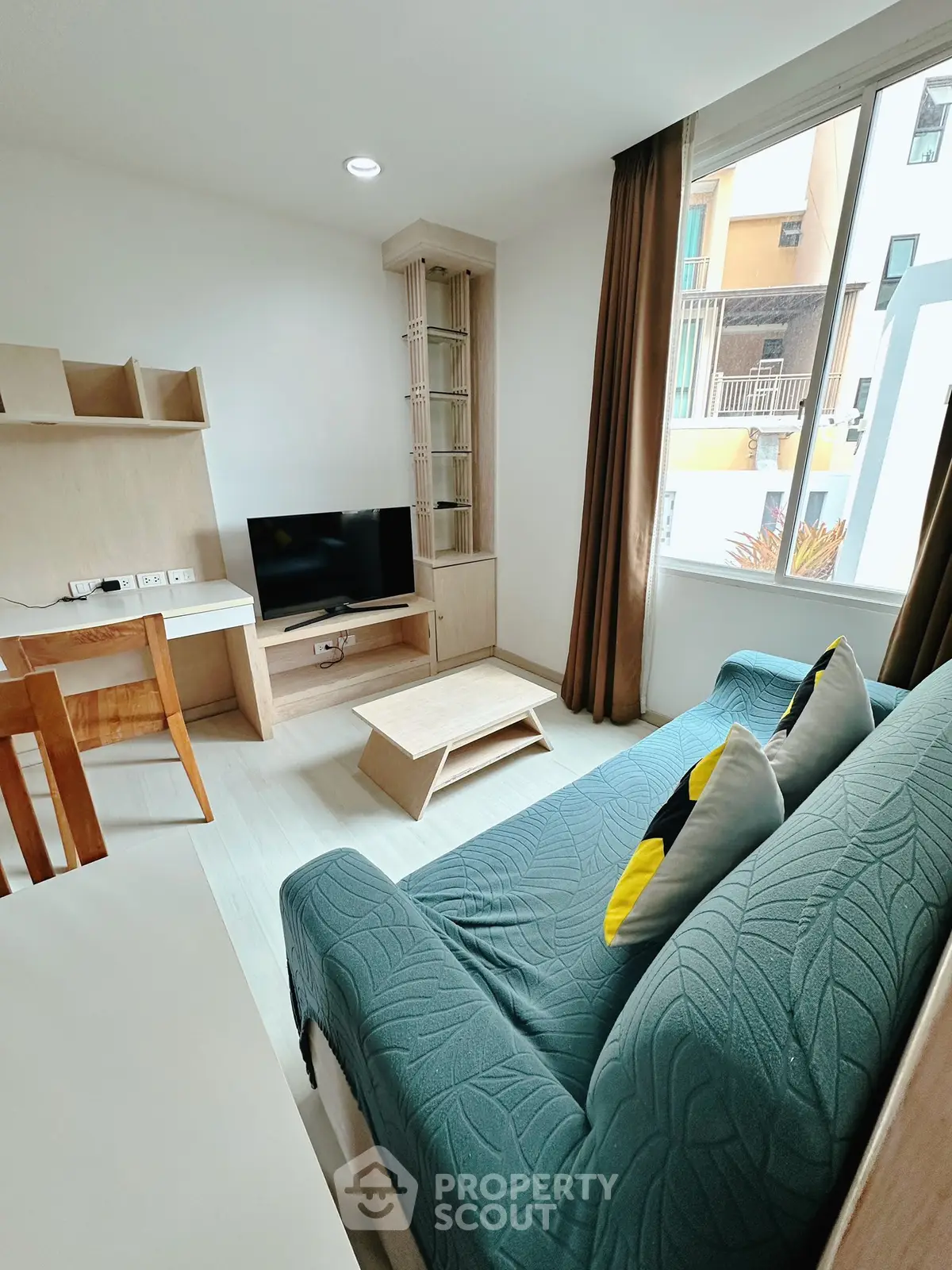 Modern living room with stylish furniture and large window for natural light