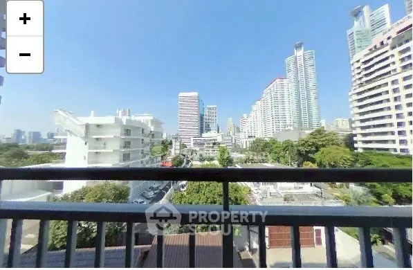 Stunning cityscape view from a high-rise balcony in urban setting.