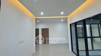 Modern interior with recessed lighting and glass partition in a spacious room