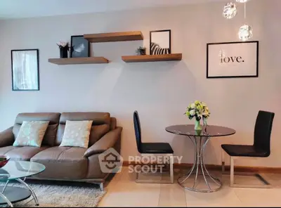 Modern living room with stylish decor, leather sofa, and elegant dining area.