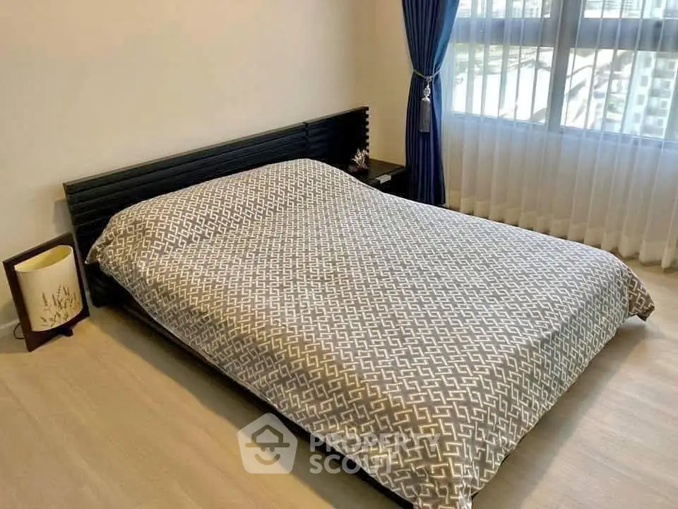 Cozy bedroom with modern bed and stylish curtains, perfect for a restful retreat.