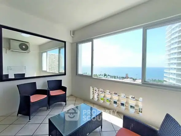 Spacious balcony with ocean view and modern seating area.