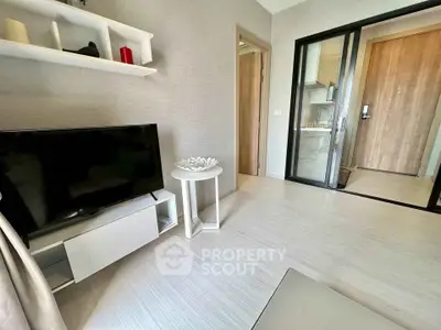 Modern living room with sleek TV setup and open kitchen view