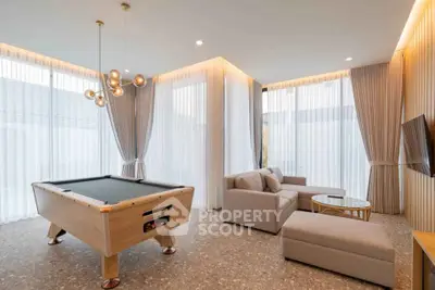 Luxurious living room with pool table and modern decor, perfect for entertainment and relaxation.
