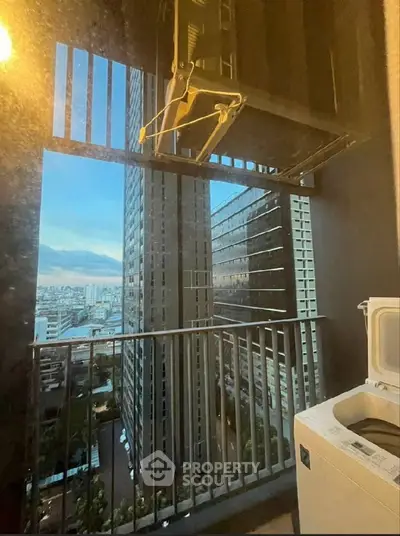 High-rise balcony with city view and washing machine, perfect for urban living.