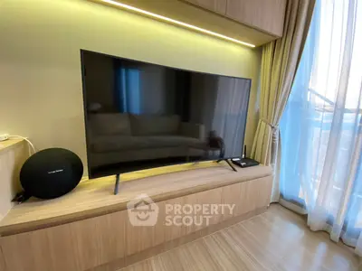 Modern living room with sleek TV setup and elegant curtains, perfect for cozy entertainment.