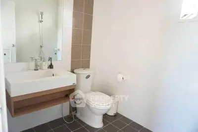 Modern bathroom with sleek fixtures and neutral tiles, perfect for a contemporary home.