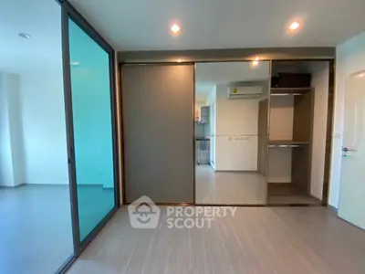 Modern apartment interior with sliding glass doors and built-in closet