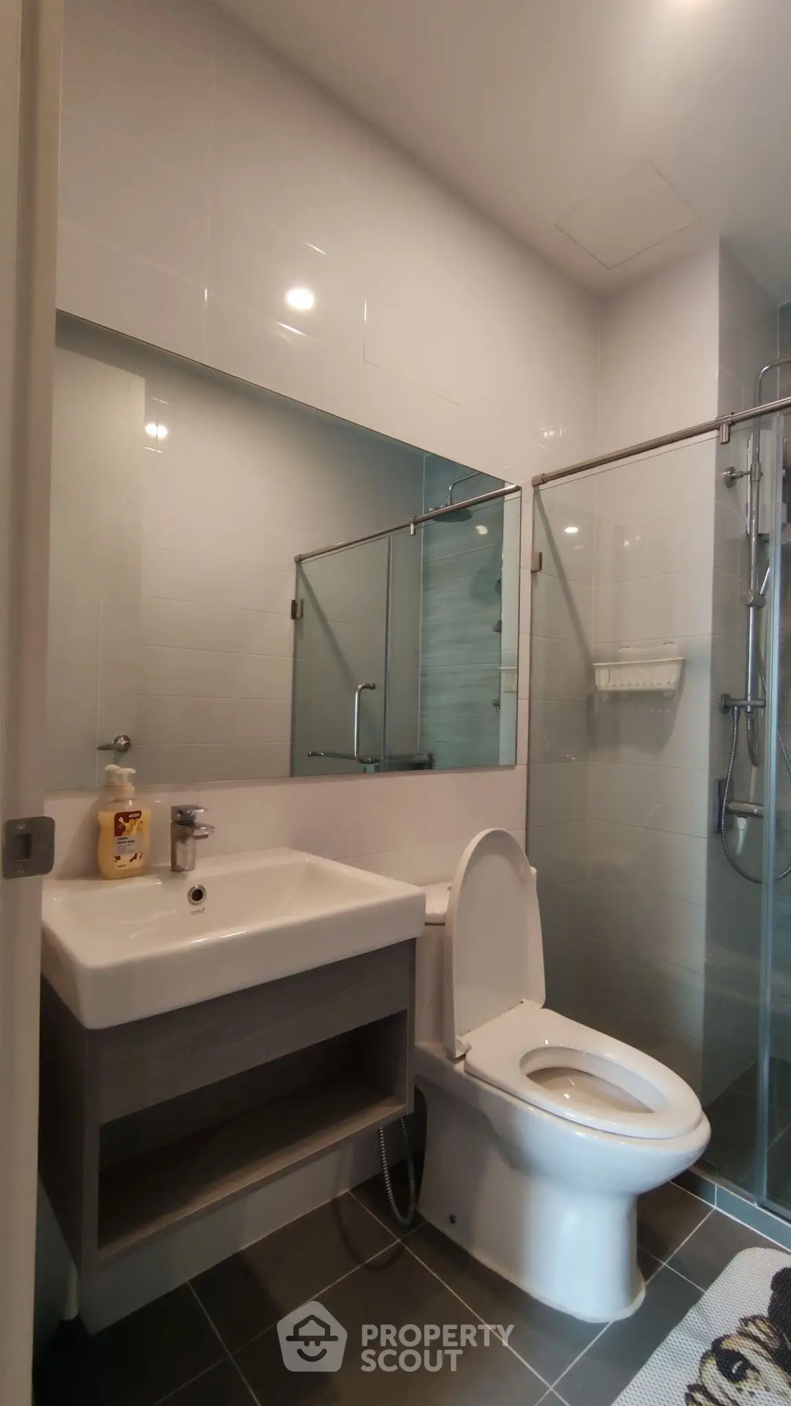 Modern bathroom with glass shower and sleek fixtures in a contemporary home.