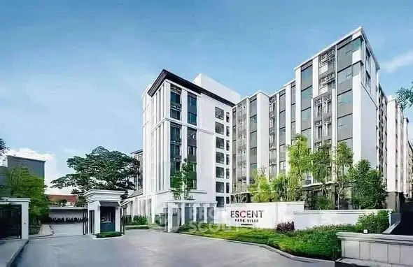 Modern residential building with lush greenery and sleek architecture in urban setting.