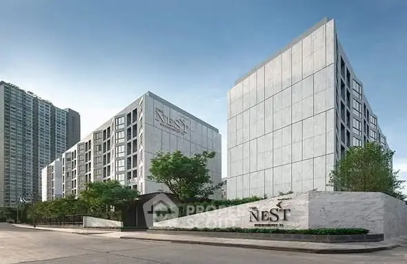 Modern luxury apartment complex with sleek architecture and lush greenery.
