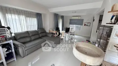 Spacious living room with modern furniture and large windows for natural light.