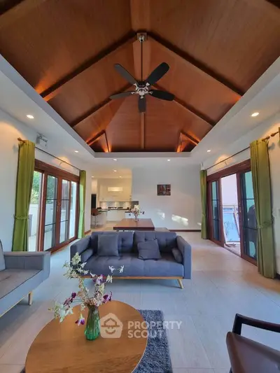 Spacious living room with high wooden ceiling and modern decor