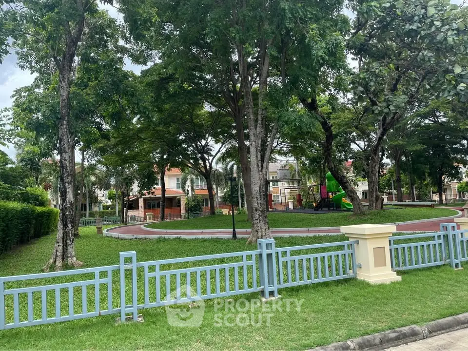 Charming residential park with lush greenery and playground, perfect for family-friendly living.