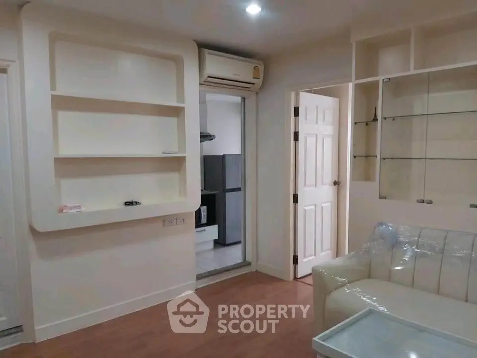 Modern living room with built-in shelves and air conditioning in cozy apartment