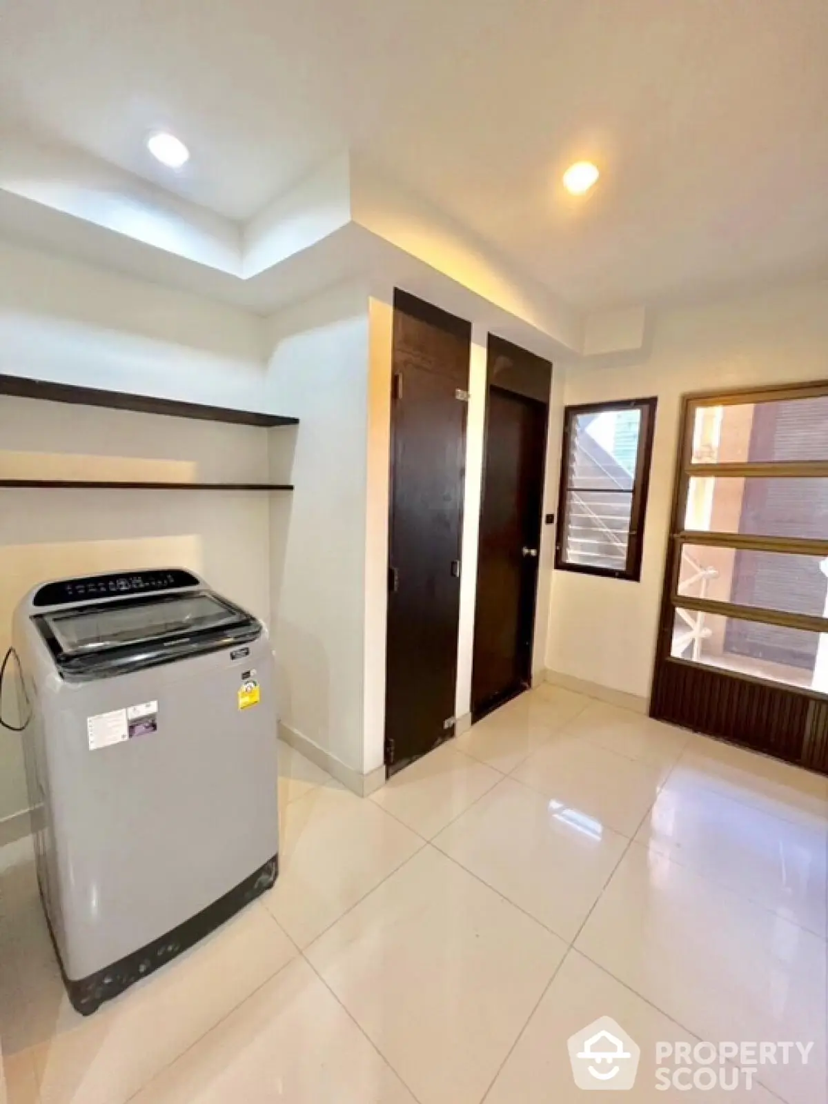 Modern laundry room with washing machine and sleek storage cabinets