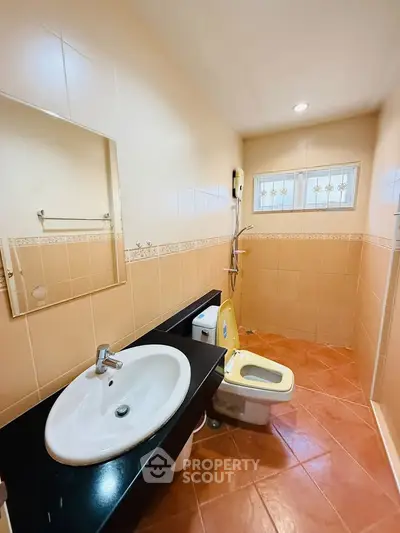 Spacious bathroom with modern fixtures and stylish tile design