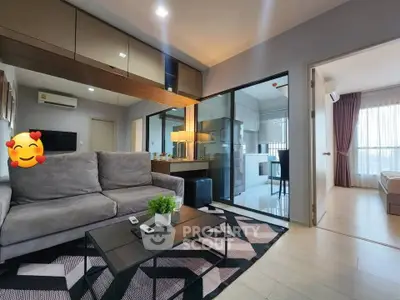 Modern living room with stylish decor and open layout to kitchen and bedroom.
