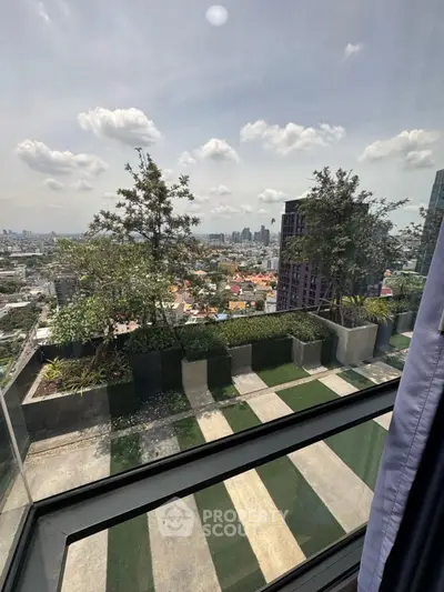 Stunning cityscape view from high-rise balcony with lush greenery and skyline.