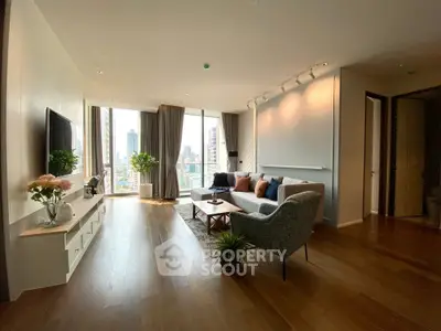 Spacious modern living room with city view, elegant decor, and natural light.