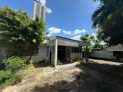 Charming vintage house with spacious yard and lush greenery, perfect for renovation or redevelopment.