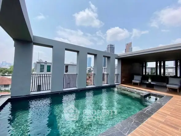 Luxurious rooftop pool with city skyline views, perfect for relaxation and entertainment.