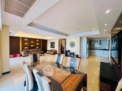 Spacious open-plan living and dining area with modern decor and ample natural light.