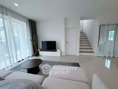 Modern living room with sleek design, large windows, and stylish furniture in a contemporary home.