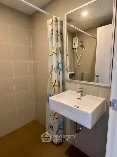 Modern bathroom with sleek sink and shower, featuring a butterfly-themed curtain for a stylish touch.
