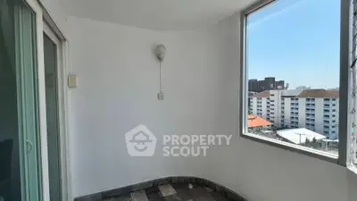 Spacious balcony with city view in modern apartment building
