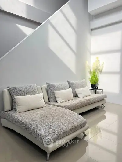 Modern living room with stylish sofas and natural light, perfect for relaxation and comfort.
