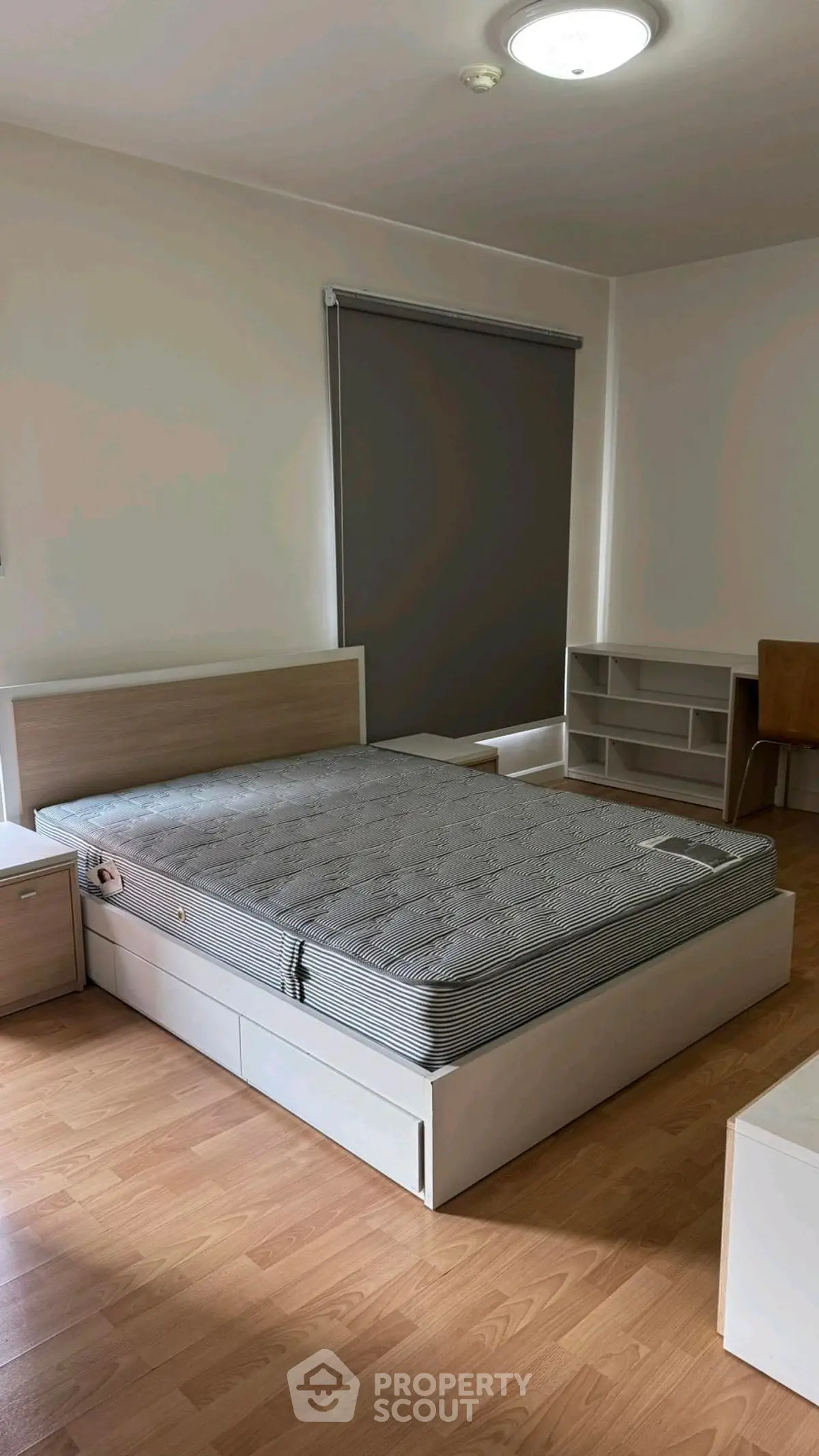 Spacious bedroom with modern furniture and natural light